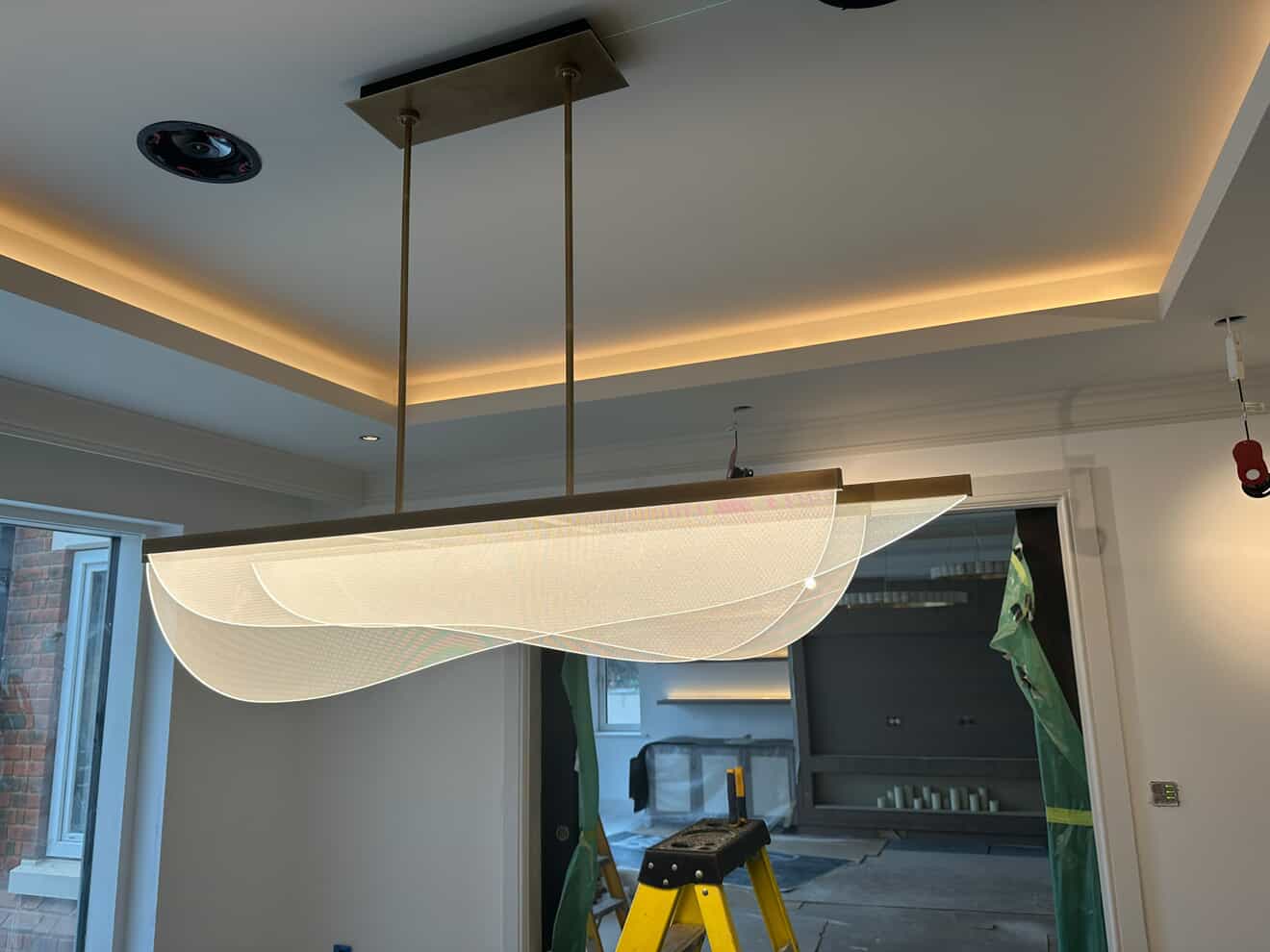 Designer pendant light fitting with LED coving and recessed downlights in entrance hallway