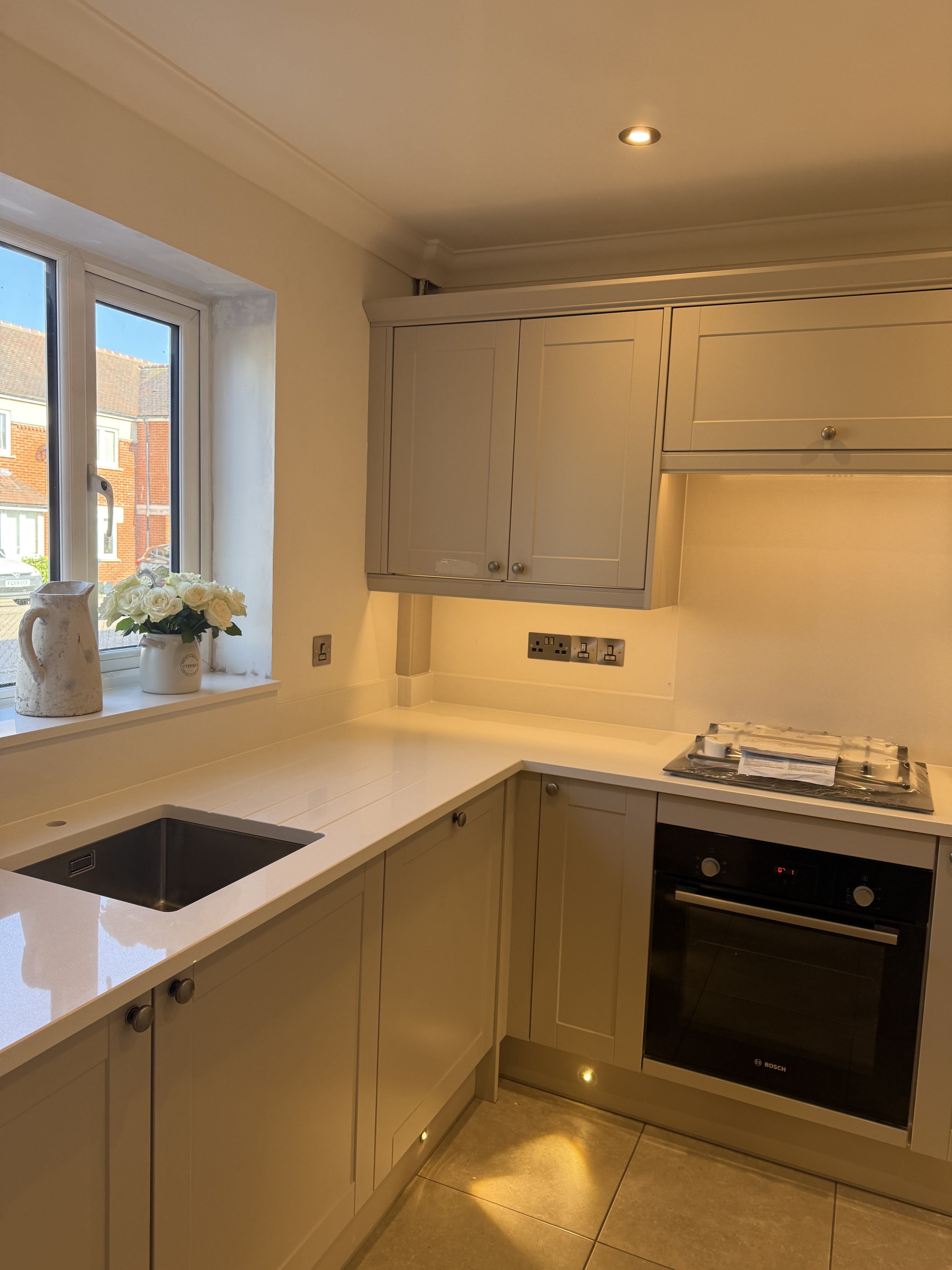 Modern kitchen with recessed LED downlights and under-cabinet task lighting in Surrey