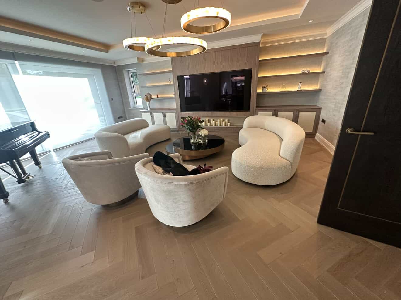 Luxury living room with smart ring chandeliers and automated LED shelf lighting