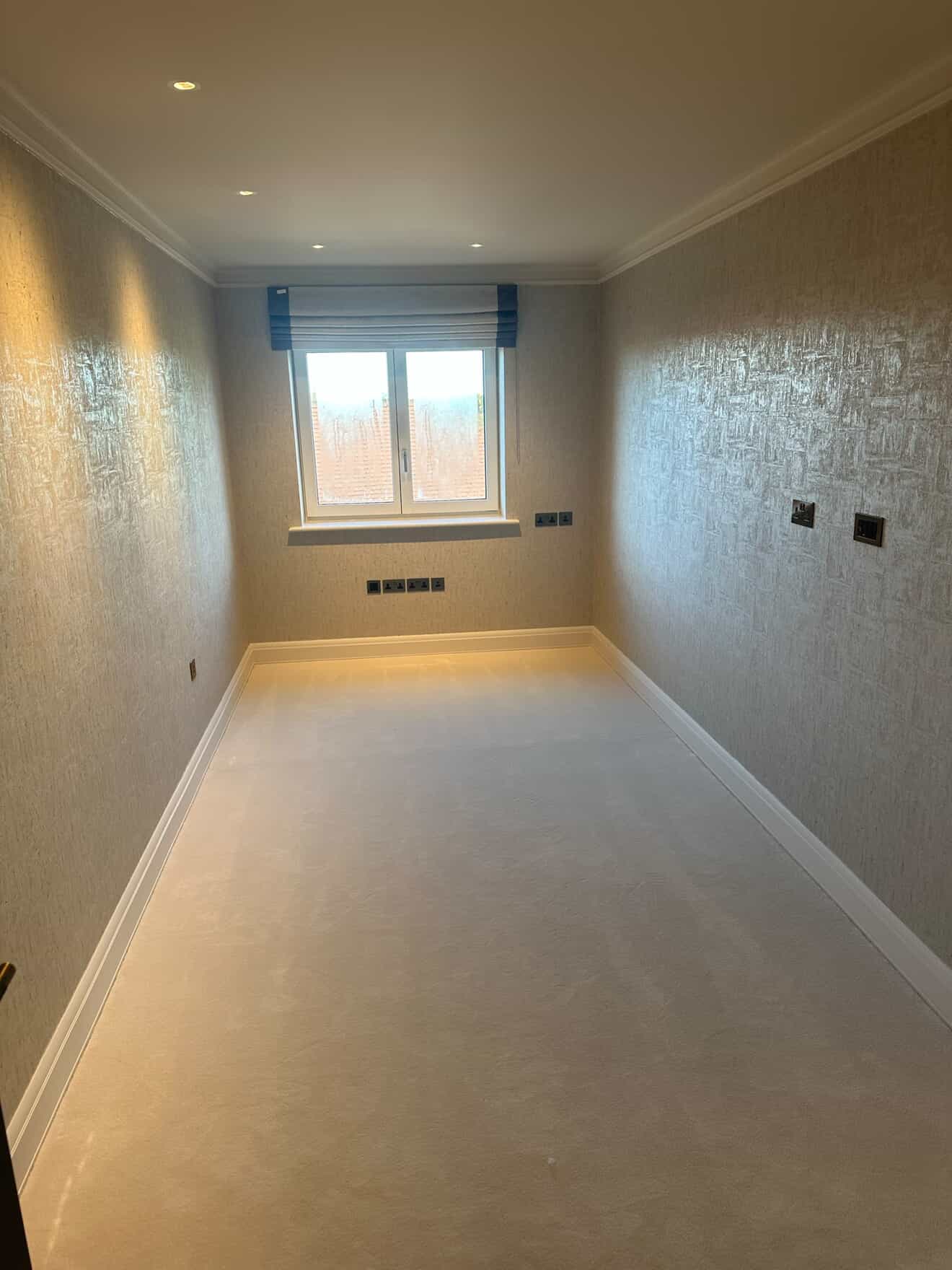 Clean white electrical sockets and light switches on a wall